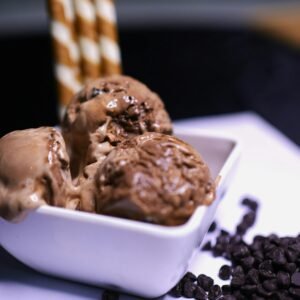 Indulge in creamy chocolate chip ice cream with wafer rolls.